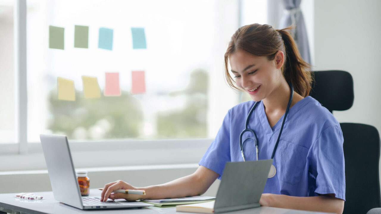 attentive nurse in scrubs reviewing medical histor 2025 03 09 16 37 13 utc 1920x1080 1